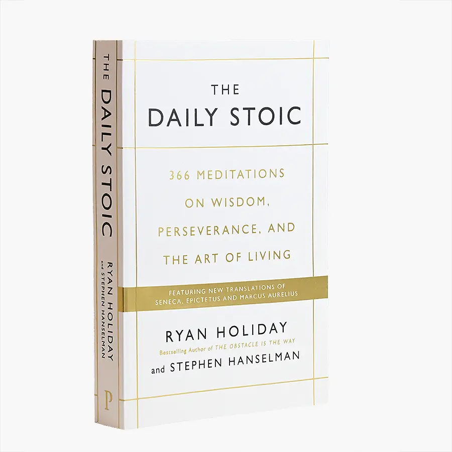 White hardcover with fine gold foil grid titling on the front board, lying on a table