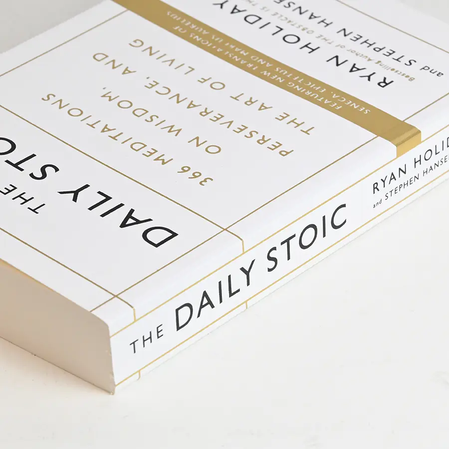 White case-bound hardcover with gold foil spine band and stamped titling